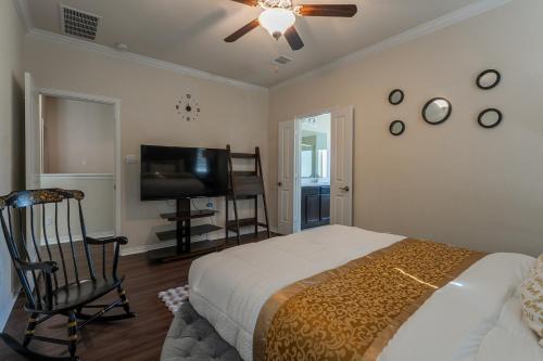 a bedroom with a bed and a flat screen tv at Blessed Home in Leander in Leander
