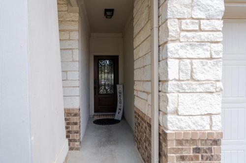 a hallway of a house with a brick wall at Blessed Home in Leander in Leander
