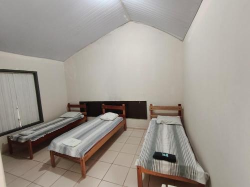 Cama o camas de una habitación en Pousada do Lago Ltda