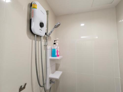a shower in a white bathroom with a shower at The base Central Pattaya 2 bedrooms in Pattaya Central
