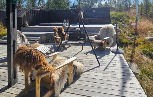 a group of animals sitting on a wooden deck at 3 Bedroom Lovely Home In Dagali in Dagali