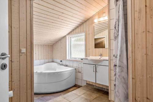 a bathroom with a white tub and a sink at OH127-Storvorde-Havornen-6 in Storvorde