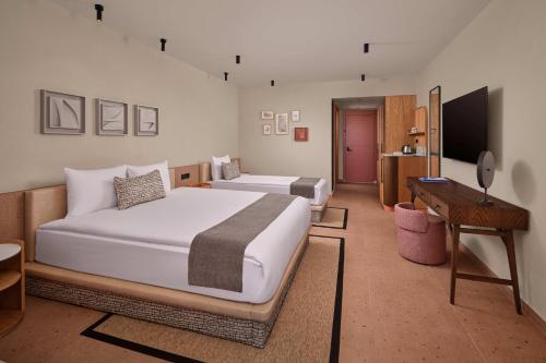 a hotel room with two beds and a desk at Paloma Grida in Belek