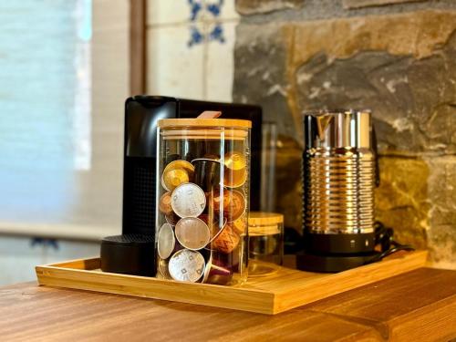 a glass jar with coins in it on a wooden table at Casa Petra in Morillo de Monclús