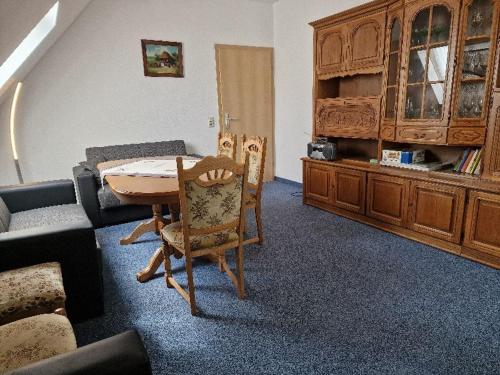 a living room with a table and chairs and a couch at FEWO Torfhaus Holzhau in Rechenberg-Bienenmühle