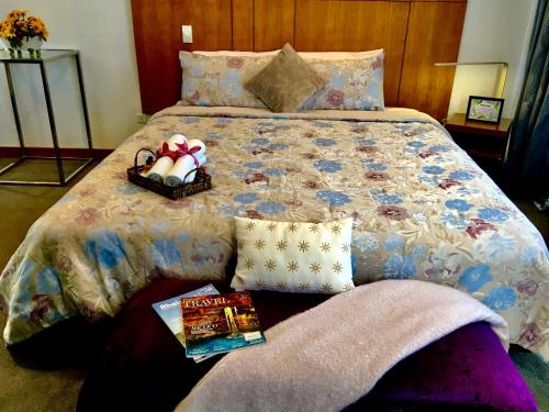 a bedroom with a bed with a book and a magazine at The Hermitage Tagaytay in Malabag