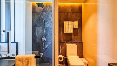 a bathroom with a shower and a toilet in it at Stunning Sea View Condo -Next To Beach in Pattaya South