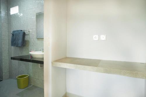 a bathroom with a sink and a toilet in it at Narmada House Seminyak in Seminyak