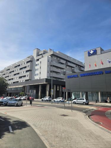 a large building with cars parked in a parking lot at Apartamento Comfort Deluxe in Rivas-Vaciamadrid