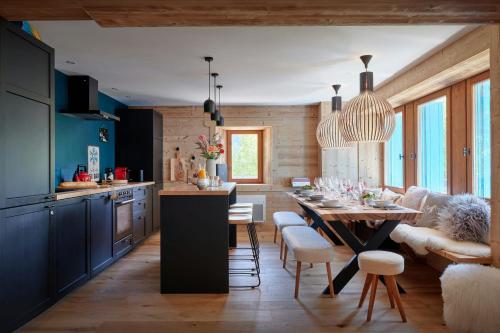a kitchen and dining room with a table and chairs at Chalet Belle Source A - OVO Network in Saint-Nicolas-la-Chapelle