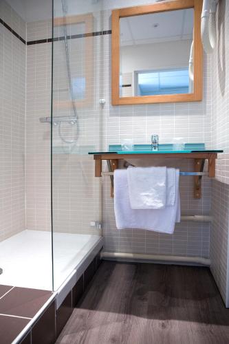 a bathroom with a shower and a sink at Hotel Du Village Catalan in Banyuls-dels-Aspres