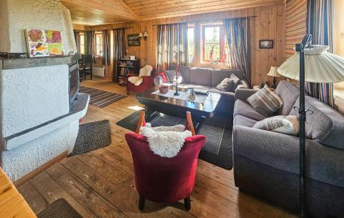 a living room with a couch and a table at 4 Bedroom Stunning Home In Tuddal in Tuddal