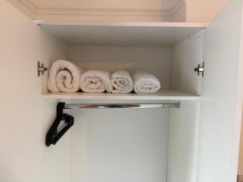 a shelf with towels on it in a bathroom at Comfortable Room 4 in Avonmouth