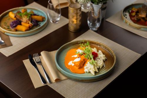 a table with two plates of food on a table at Benczur Hotel in Budapest