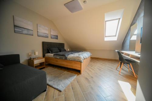 a bedroom with a bed and a desk at Hidden Gem in Novi Sad