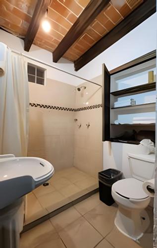 a bathroom with a toilet and a sink at Doña Vicenta Casa Colonial in Guanajuato