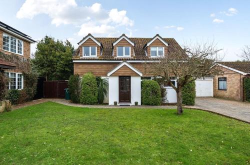 a house with a green lawn in front of it at Locksash Close - West Wittering in West Wittering