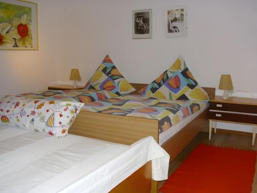 a bedroom with two beds and a table with a desk at Gästehaus Brigitte Kienzler in Gremmelsbach