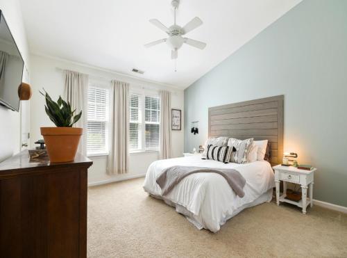 a white bedroom with a bed and a ceiling fan at Hotel Luxury Villas Near IGI Delhi Airport in New Delhi