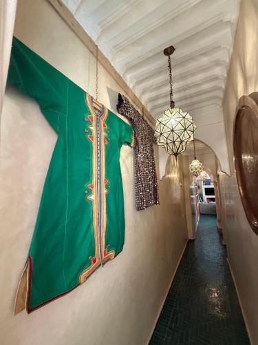 a hallway with a green flag on the wall at Riad Atrium & Spa in Marrakech