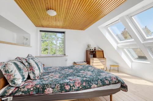 a bedroom with a bed in a room with skylights at 6763-Allinge-Sdr-Strandvej-69 in Allinge