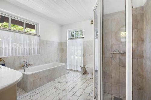 a bathroom with a tub and a toilet and a sink at 6763-Allinge-Sdr-Strandvej-69 in Allinge