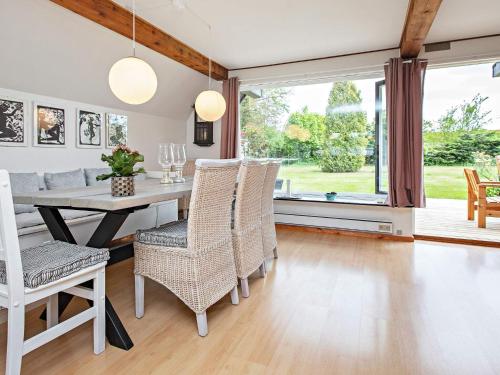 a dining room with a table and chairs at 4 star holiday home in Væggerløse in Bøtø By