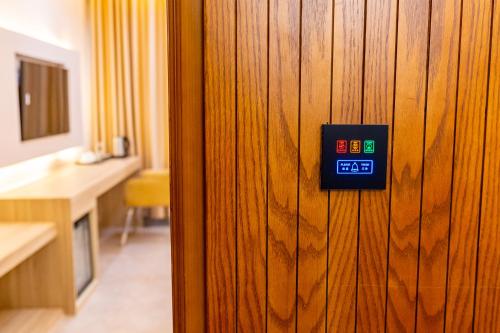 a clock on a wooden door in a room at Emerald Dhaka Luxury Hotel in Dhaka