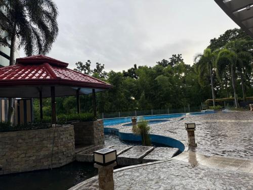 a pool at a resort with a gazebo at Executive Suites Bellagio Golf View Residences in Manila