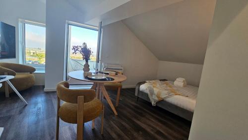 a small room with a bed and a table and a window at A Proa do Moliceiro Canal da Ria Lagoon Views in Aveiro