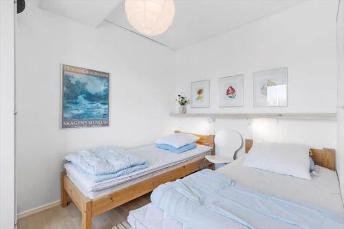 two beds in a room with white walls at 5430-Gudhjem-Gudhjemvej-111-D-1-lejl-5 in Gudhjem