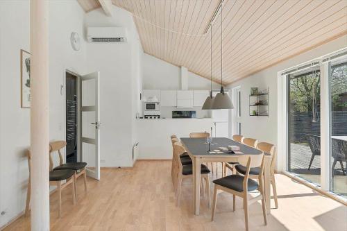 a kitchen and dining room with a table and chairs at 4801-Ronne-Stampen-Vej-6-Hus-7 in Rønne