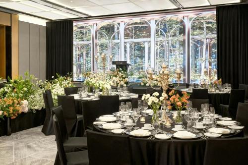 a banquet hall with tables and chairs and flowers at Courtyard by Marriott Pyeongtaek in Pyeongtaek