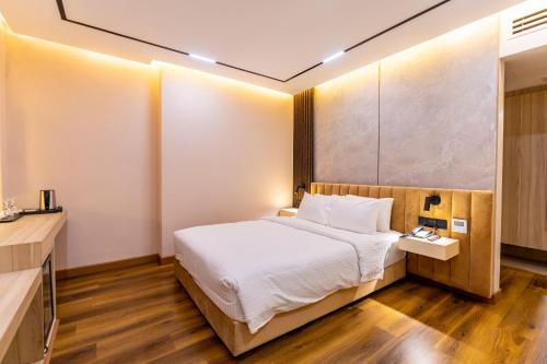 a hotel room with a bed and a desk at Emerald Dhaka Luxury Hotel in Dhaka