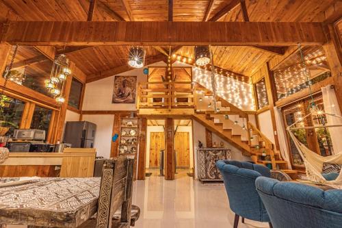 a living room with a staircase in a house at 2 Magical Villas with Yoga Shala up to 23 guests in Patos