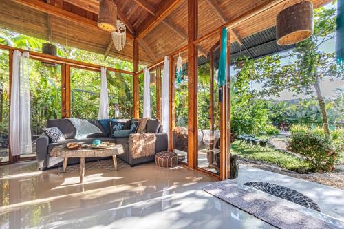 a living room with a couch and a table at 2 Magical Villas with Yoga Shala up to 23 guests in Patos