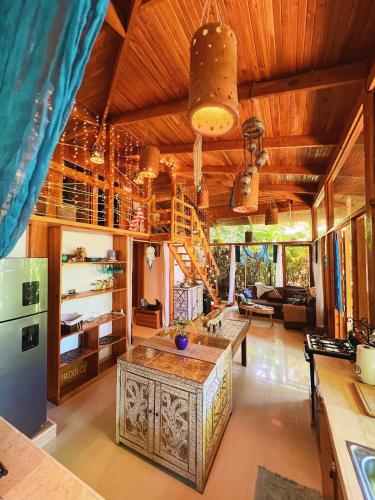 an open kitchen with a large wooden ceiling at 2 Magical Villas with Yoga Shala up to 23 guests in Patos