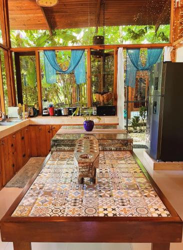 a kitchen with a large table in the middle at 2 Magical Villas with Yoga Shala up to 23 guests in Patos