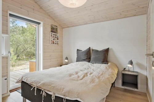 a bedroom with a large bed and a television at OH522-Hadsund-Vidjeparken-18 in Hadsund