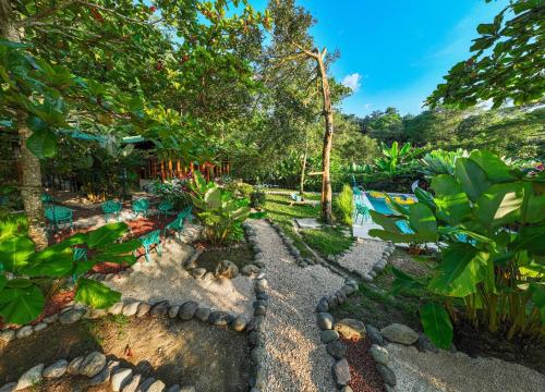a garden with rocks and plants and trees at 2 Magical Villas with Yoga Shala up to 23 guests in Patos
