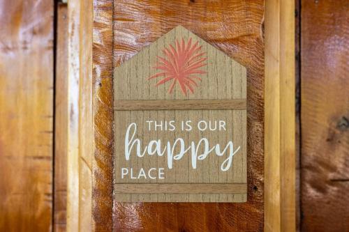 a sign that says this is our happy place on a wall at 2 Magical Villas with Yoga Shala up to 23 guests in Patos
