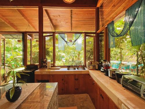 a kitchen with a sink and some windows at 2 Magical Villas with Yoga Shala up to 23 guests in Patos