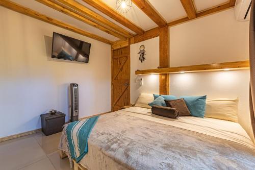 a bedroom with a large bed in a room at 2 Magical Villas with Yoga Shala up to 23 guests in Patos