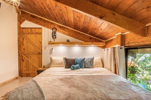 a bedroom with a large bed with a wooden ceiling at 2 Magical Villas with Yoga Shala up to 23 guests in Patos