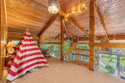 a room with an american flag tent in a cabin at 2 Magical Villas with Yoga Shala up to 23 guests in Patos