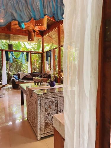 a living room with a table and a couch at 2 Magical Villas with Yoga Shala up to 23 guests in Patos
