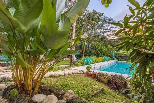 a garden with a swimming pool and some plants at 2 Magical Villas with Yoga Shala up to 23 guests in Patos