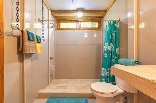 a bathroom with a shower and a toilet at 2 Magical Villas with Yoga Shala up to 23 guests in Patos