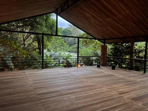 a large wooden deck with a view of a forest at 2 Magical Villas with Yoga Shala up to 23 guests in Patos