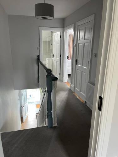 a hallway with a stairway with a stair case at 2 Cois Chnoic - Dingle holiday home in Dingle